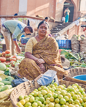 Indian seller with fresh fruit and vegetables (photo)
